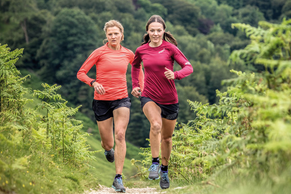 two women running on trail